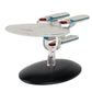 Model of a Star Trek ship on a black base with a white background